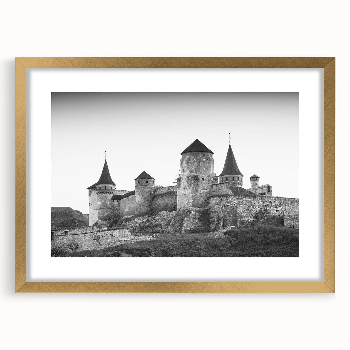 Framed gold wall art displaying a picturesque landscape with a castle, featuring a matting design that enhances its elegance and charm for home decor.