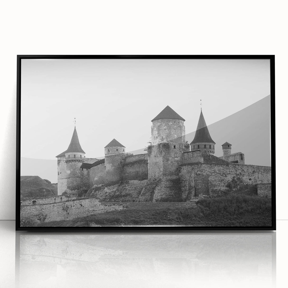 Framed wall art showcasing a stunning landscape of a castle, featuring intricate details and vibrant colors, displayed in a sleek black frame, perfect for home decor.