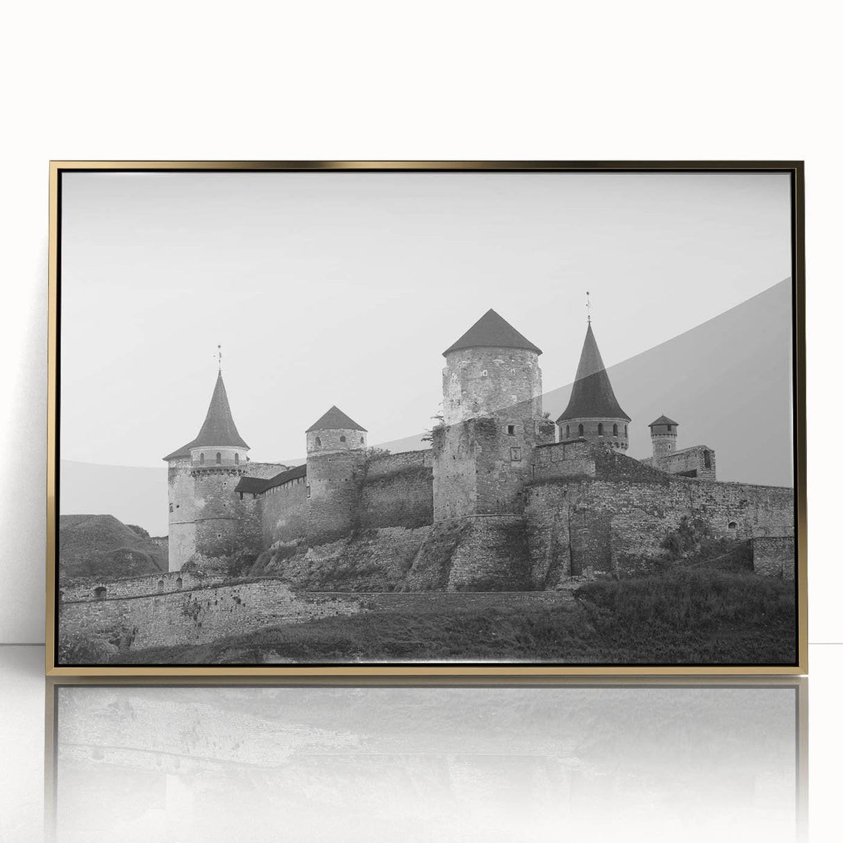 Framed wall art featuring a scenic landscape of a majestic castle, highlighted with gold accents and a sleek acrylic front, perfect for home decor.