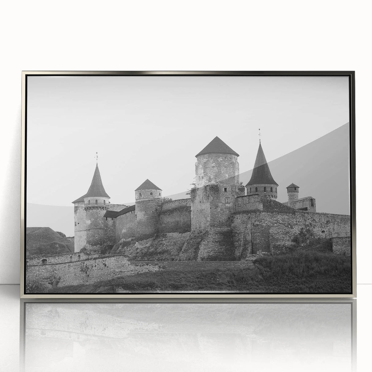Framed acrylic wall art showcasing a stunning landscape with a majestic castle, featuring a silver frame that enhances the artwork's elegance, ideal for home decor.