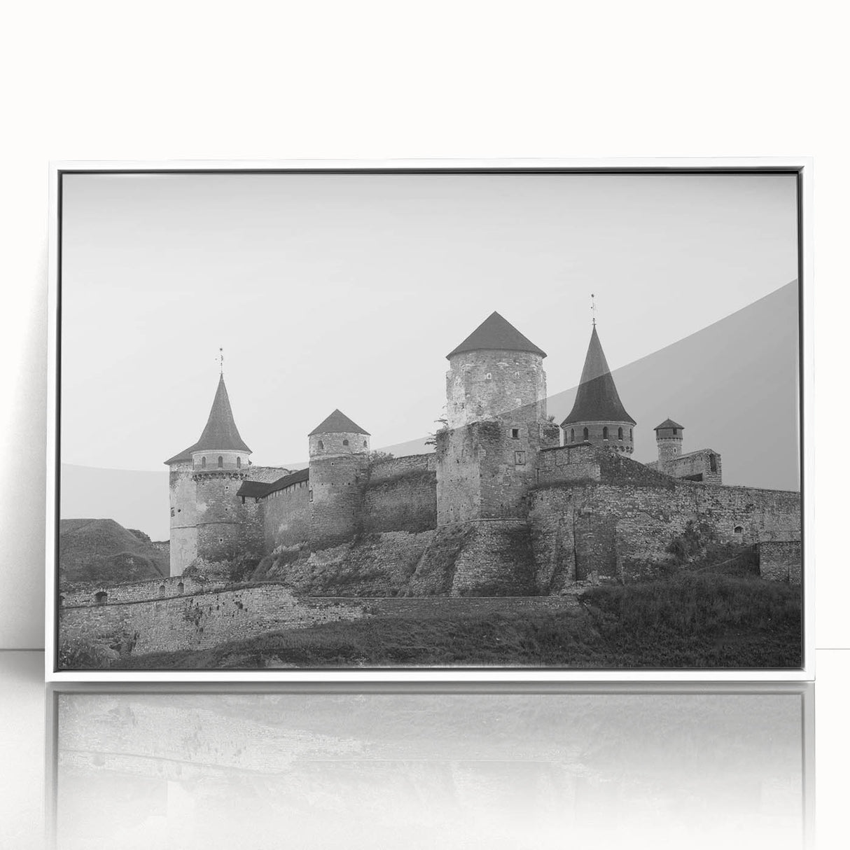 Framed wall art featuring a serene landscape with a castle, displayed in a sleek white frame, highlighting intricate details and vibrant colors, perfect for home decor.