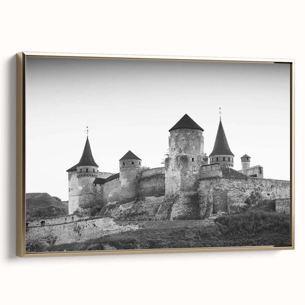 Framed canvas wall art showcasing a landscape of a majestic castle surrounded by lush greenery, highlighted by a gold frame for an elegant touch. Ideal for home decor.