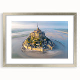 Framed wall art featuring a stunning landscape of a medieval castle, presented in a silver frame with a mat, ideal for enhancing home decor and adding elegance.