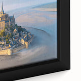 Close-up of a framed canvas artwork depicting a picturesque landscape with a majestic castle, rich colors, and intricate details, perfect for home decor.