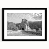 Framed wall art featuring a stunning landscape of a castle, set in a black frame with a white mat, showcasing intricate details and vibrant colors, perfect for home decor.