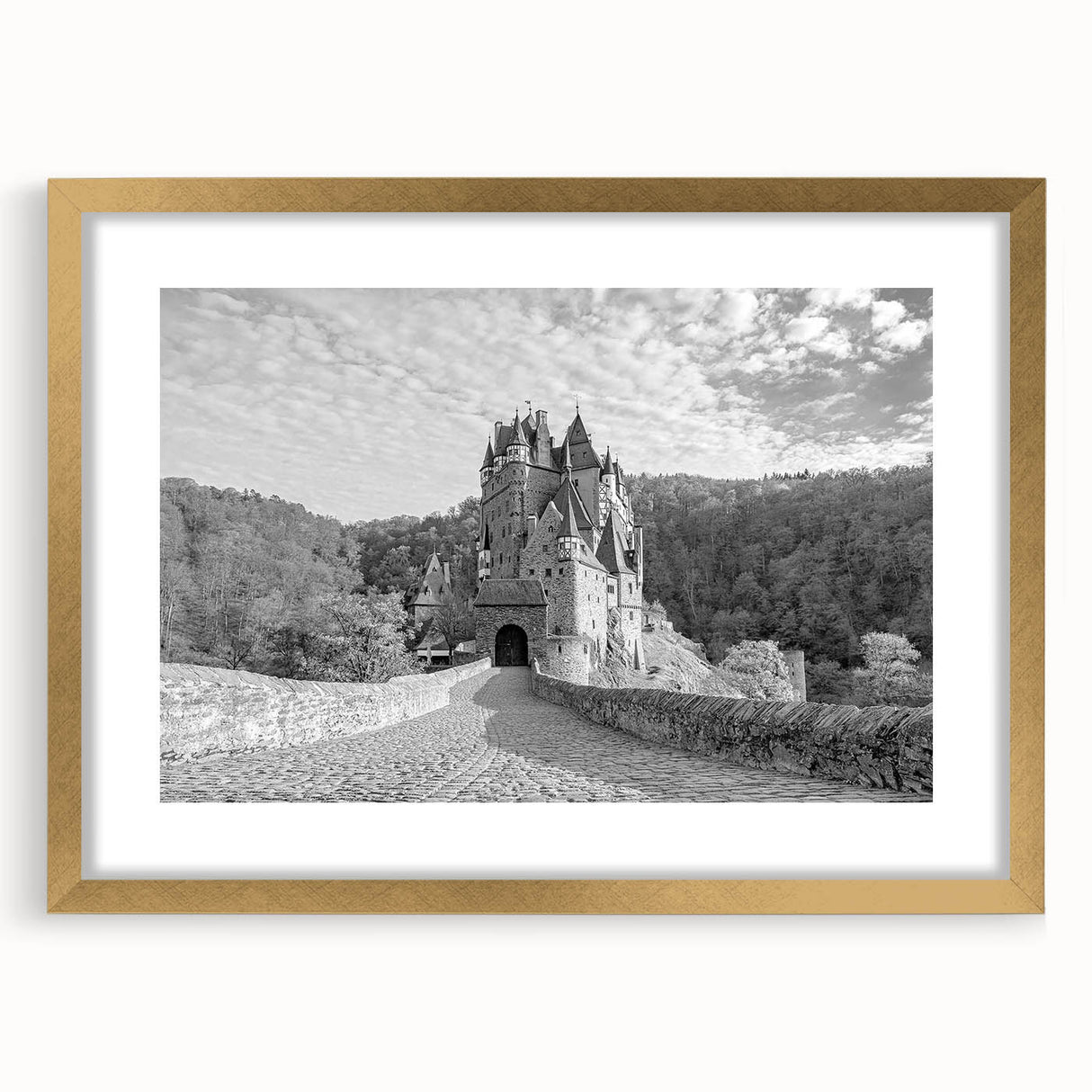 Elegant wall art featuring a gold-framed landscape of a majestic castle, complete with a mat surrounding the artwork, ideal for enhancing home decor and creating a regal ambiance.