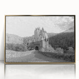 Framed wall art featuring a stunning landscape of a medieval castle surrounded by lush greenery, presented in an elegant gold frame that enhances its beauty.