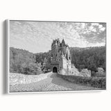 Framed canvas wall art showcasing a majestic castle landscape with vibrant colors, elegantly displayed in a white frame, perfect for home decor enhancement.