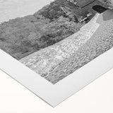 Rolled canvas artwork showcasing a vibrant landscape of a majestic castle surrounded by lush greenery and a clear blue sky, ideal for home decor.