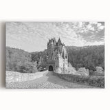 Stretched canvas wall art featuring a stunning landscape of a medieval castle surrounded by lush greenery and a clear blue sky, perfect for adding elegance to home decor.