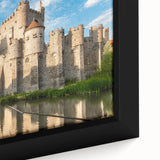 Framed canvas artwork showcasing a vibrant landscape with a majestic castle, surrounded by lush greenery and a clear blue sky, perfect for enhancing home decor.
