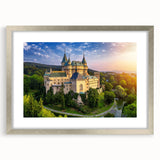 Elegant silver-framed wall art showcasing a stunning landscape castle design, complete with a mat for added depth, perfect for enhancing home decor.