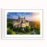 Framed wall art featuring a stunning landscape of a majestic castle, presented in a sleek white mat and frame, perfect for home decor and interior design enthusiasts.