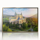 Framed acrylic wall art featuring a breathtaking landscape of a castle, adorned with a gold frame, ideal for home decor and showcasing elegance in any setting.