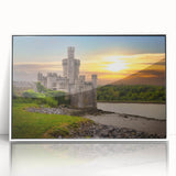 Framed wall art showcasing a stunning landscape of a majestic castle surrounded by lush greenery, featuring a sleek white border for a modern aesthetic.