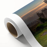 Rolled canvas wall art showcasing a stunning landscape with a majestic castle set against a vibrant sunset, ideal for home decor enthusiasts. The artwork features rich colors and intricate details, enhancing any interior space.