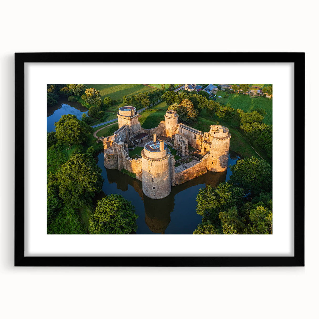 Framed wall art featuring a stunning landscape of a castle, set in a sleek black frame with a white mat, perfect for enhancing home decor and interior aesthetics.