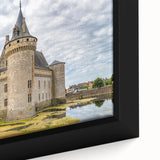 Close-up of a framed canvas featuring a vibrant landscape of a medieval castle surrounded by lush greenery, showcasing intricate details and rich colors, perfect for home decor.