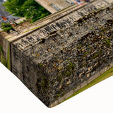 Close-up of a stretched canvas wall art piece displaying a scenic landscape of a majestic castle, featuring vibrant colors and intricate detail, perfect for home decor.