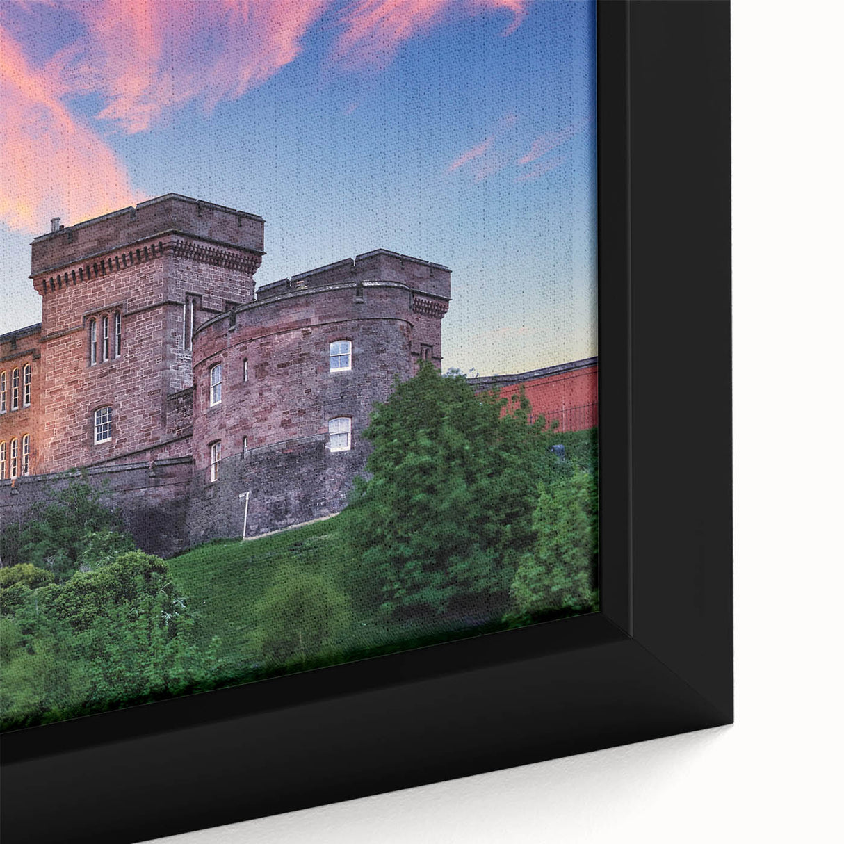 Close-up of a framed canvas showcasing a vibrant landscape with a majestic castle, surrounded by lush greenery and a clear blue sky, perfect for home decor.