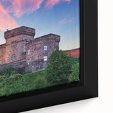 Close-up of a framed canvas showcasing a vibrant landscape with a majestic castle, surrounded by lush greenery and a clear blue sky, perfect for home decor.