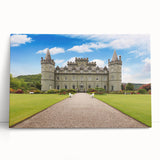Stretched canvas wall art featuring a serene landscape with a majestic castle surrounded by lush greenery, leaning against a wall for display. The artwork evokes tranquility and charm, ideal for home decor.