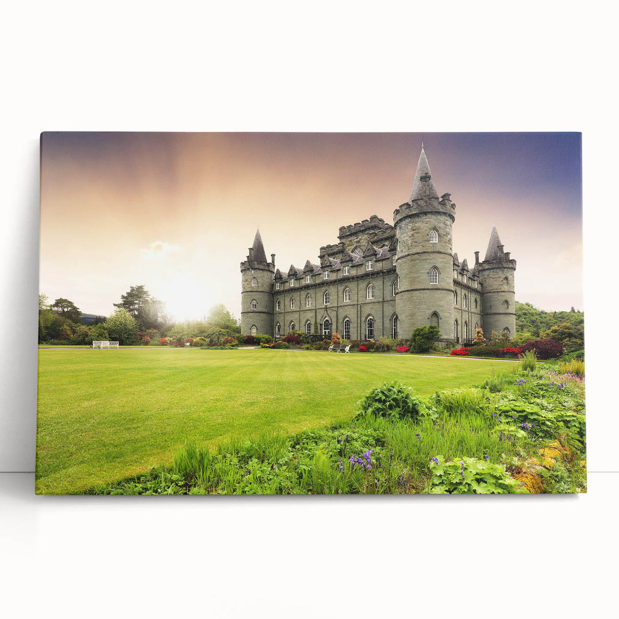 Stretched canvas artwork showcasing a picturesque landscape with a majestic castle surrounded by lush greenery, ideal for home decor enthusiasts and art collectors.