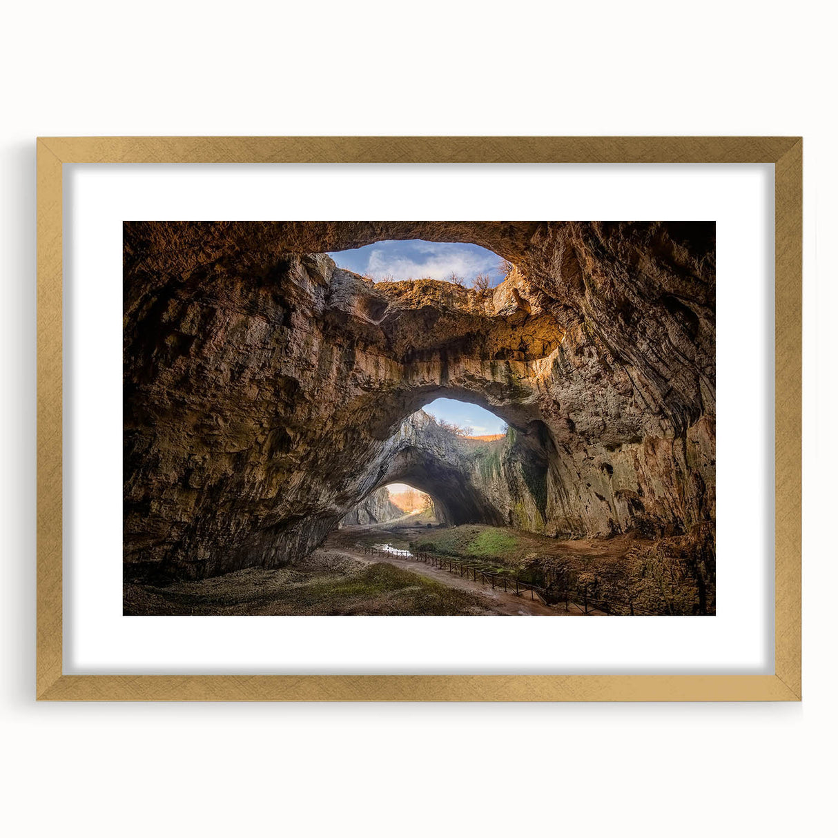 Framed wall art featuring an elegant cave landscape design, presented in a gold frame with a white mat, perfect for enhancing home decor.