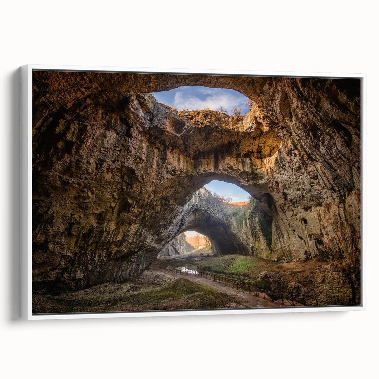 Framed canvas wall art showcasing a stunning landscape with cave formations, featuring a white frame. Ideal for home decor, enhancing modern interiors with natural beauty.