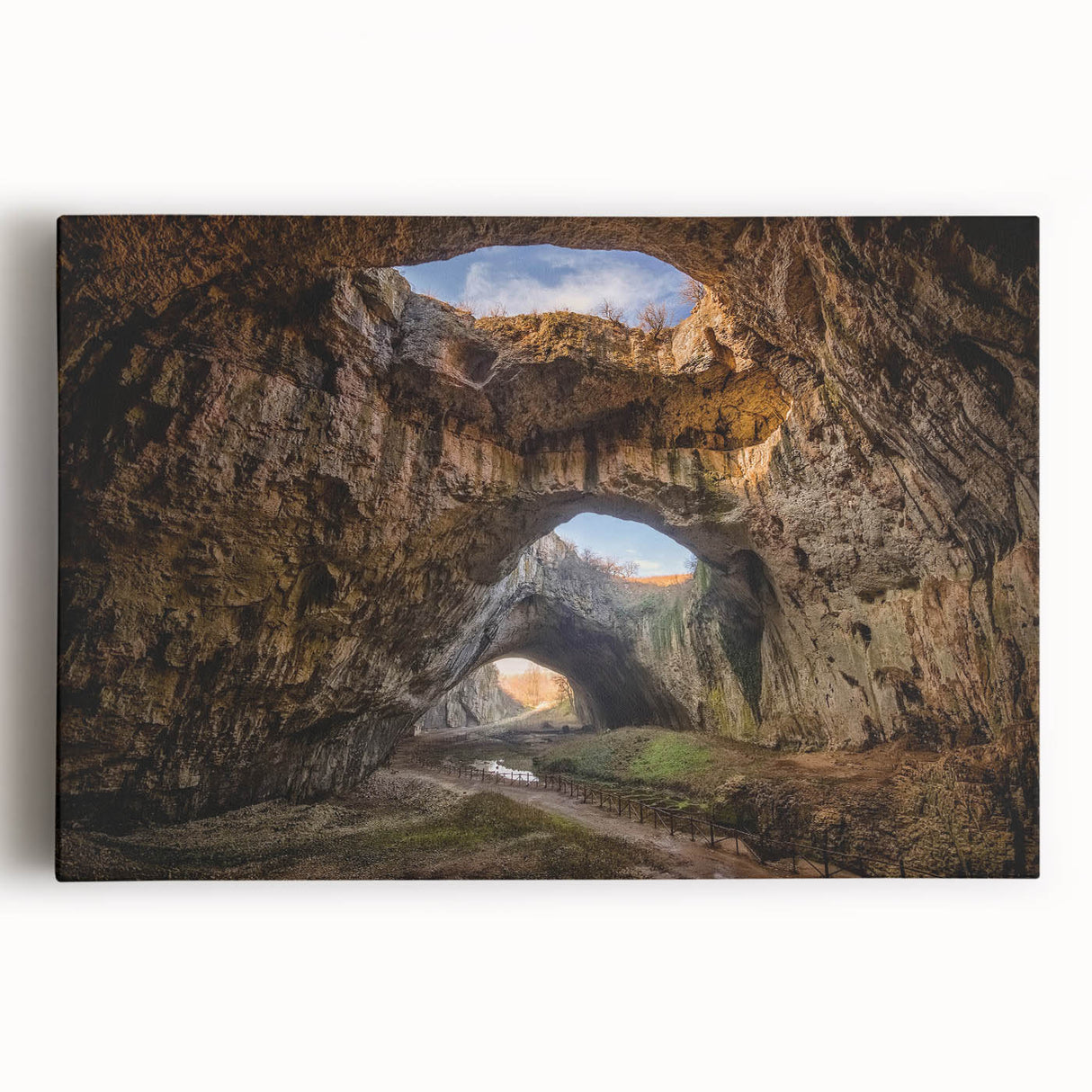 Stretched canvas wall art showcasing a vibrant landscape scene with intricate cave designs, ideal for home decor. Perfect for adding a touch of nature-inspired elegance to any room.
