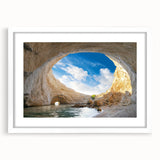 Framed wall art featuring a serene landscape with caves and mountains, set in a white mat, perfect for enhancing home decor with a touch of nature.