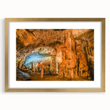 Framed wall art featuring a stunning landscape design with caves, set in a gold frame with a mat. This elegant piece adds a touch of sophistication to any room decor.