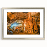 Framed wall art collection featuring a landscape and cave design in silver frame, with a white mat for a refined aesthetic, perfect for modern home decor.