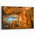Framed canvas artwork showcasing a stunning landscape of caves with intricate details and vibrant colors, featuring a sleek black frame that enhances its elegance.