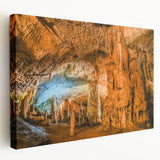 Stretched canvas wall art showcasing a vibrant abstract landscape with rich earthy tones and intricate cave designs, ideal for modern home decor.