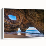 Framed canvas wall art featuring a serene landscape design with caves, showcasing earthy tones and textures, displayed from a side view against a white background.