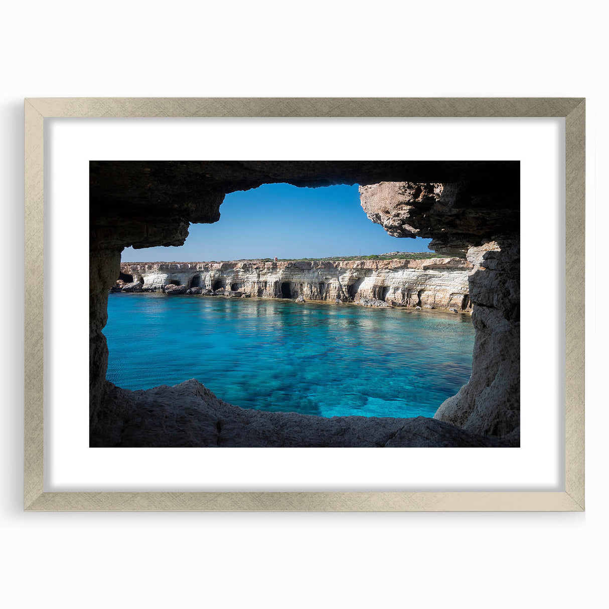 Framed wall art collection showcasing a serene landscape with cave designs, featuring a silver mat and elegant frame, perfect for enhancing interior decor.