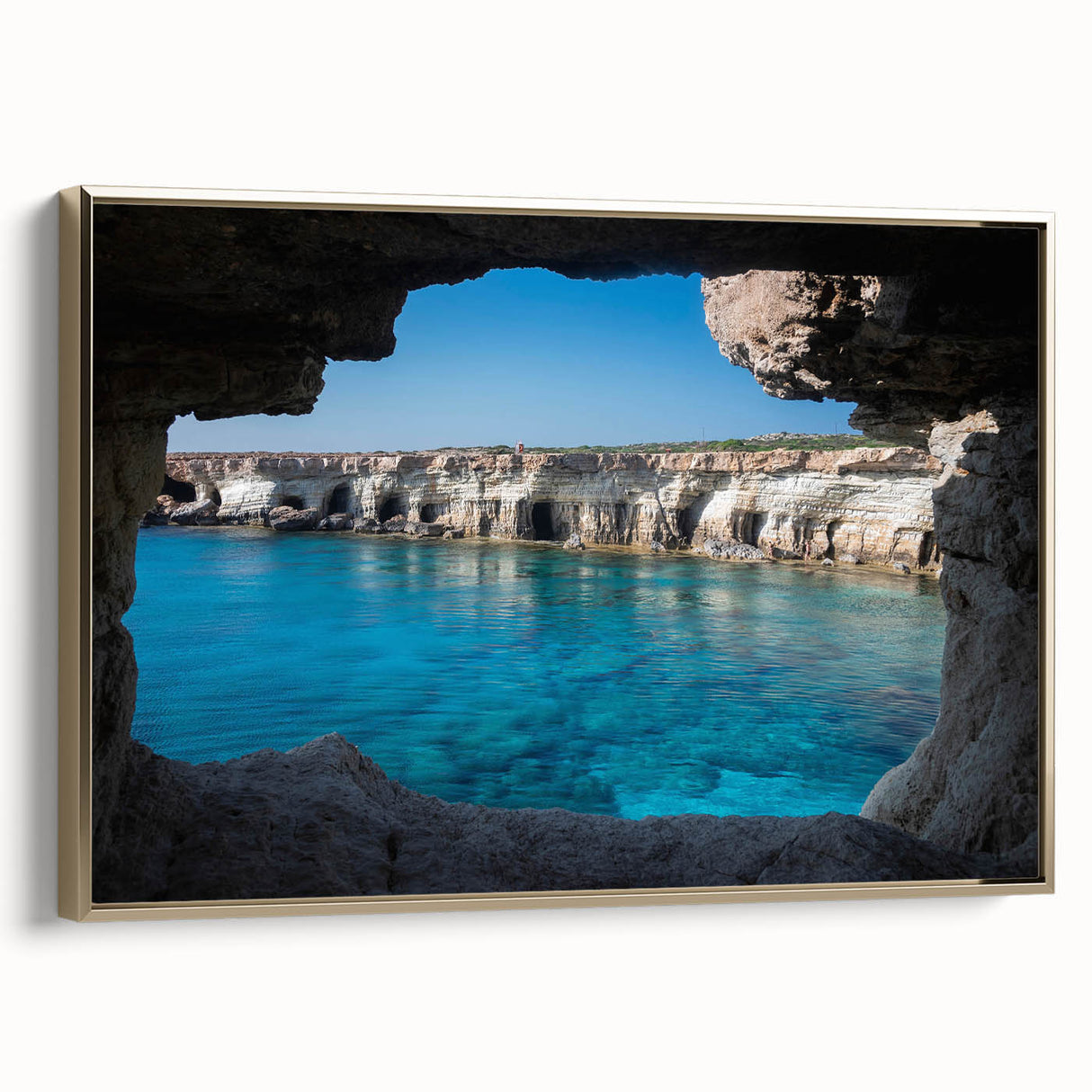 Framed canvas wall art showcasing a stunning landscape of caves with intricate designs, featuring a gold frame that enhances its elegance and visual appeal.