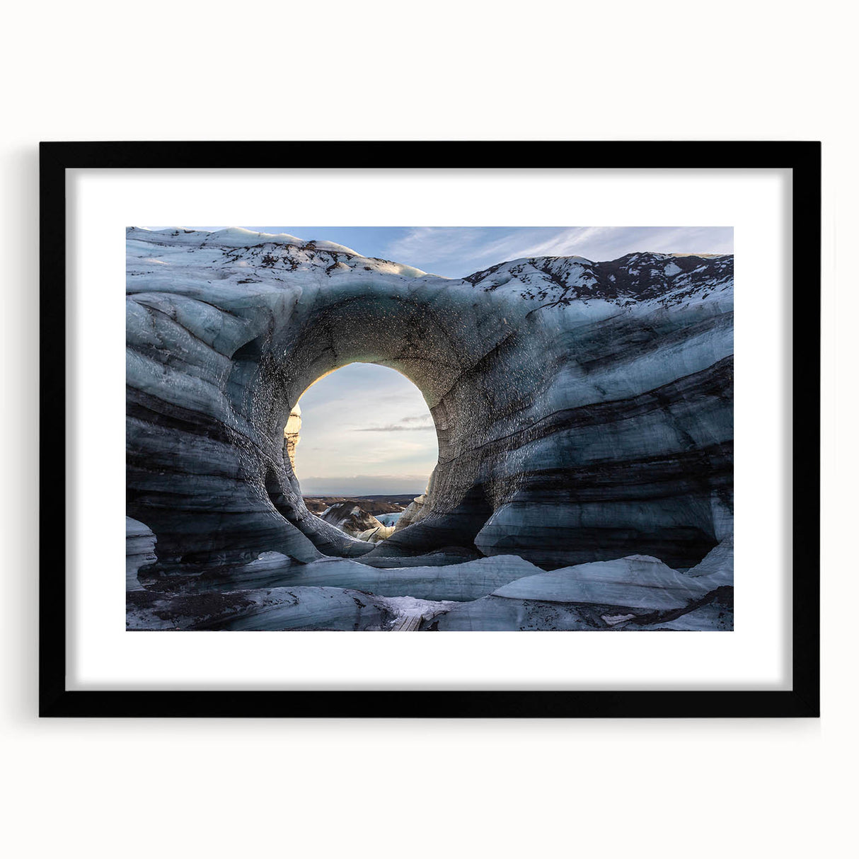 Framed wall art featuring a stunning landscape design with cave motifs, presented in a sleek black frame and a white mat, ideal for modern home decor.