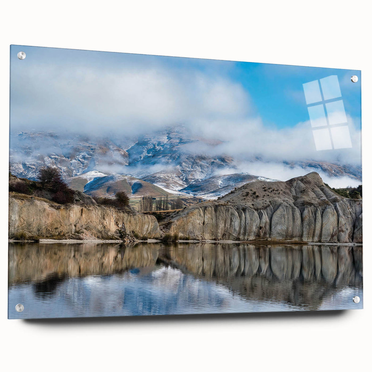 Side view of an acrylic glass wall art piece showcasing a stunning landscape of cliffs, elegantly displayed with pins on a minimalist background, adding a modern touch to any decor.
