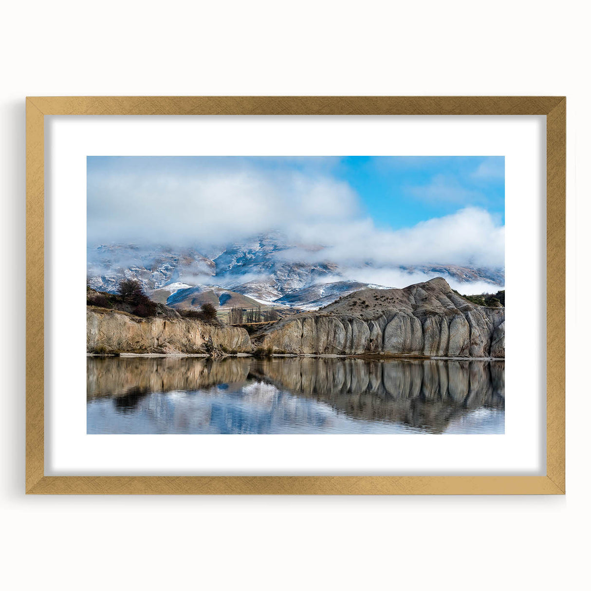 Framed wall art featuring a stunning landscape of cliffs with a textured mat, elegantly designed in gold. Perfect for modern home decor and art collectors.