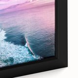 Close-up of a framed canvas featuring a stunning landscape of rugged cliffs and serene ocean waves, showcasing vibrant colors and intricate details, perfect for home decor.