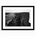 Framed wall art featuring a scenic landscape of cliffs, presented in a sleek black frame, perfect for enhancing modern home decor with natural beauty.