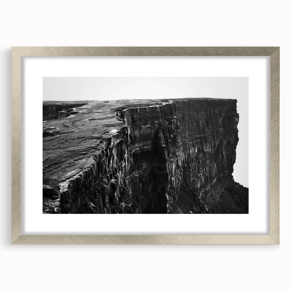 Framed wall art featuring a stunning landscape of cliffs, accented with a silver mat, perfect for enhancing modern home décor. The artwork showcases vibrant colors and intricate details, ideal for adding a touch of elegance to any room setting.