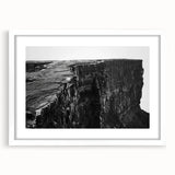 White-framed wall art showcasing a stunning landscape of cliffs and vibrant skies, designed to enhance home decor with its natural beauty and calming colors.