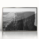 Framed wall art featuring an abstract landscape design with cliffs and vibrant colors, elegantly displayed in a silver frame, ideal for modern home decor.