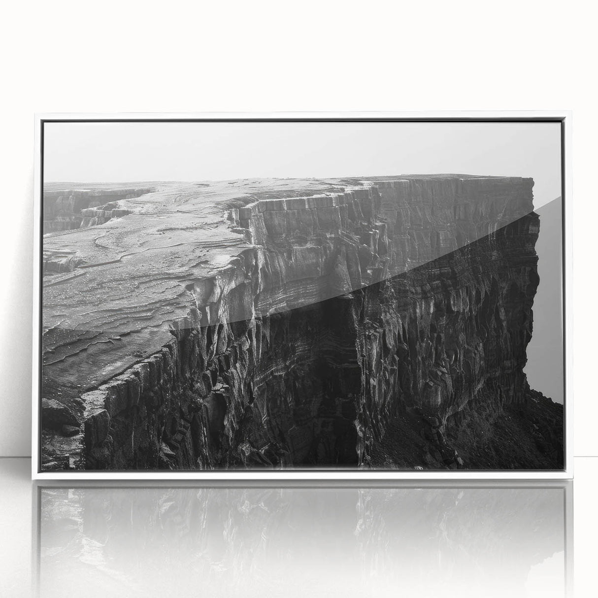 Framed wall art featuring a stunning landscape of cliffs, highlighted by vibrant colors, displayed in a sleek white frame, perfect for modern home decor.