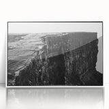 Framed wall art featuring a stunning landscape of cliffs, highlighted by vibrant colors, displayed in a sleek white frame, perfect for modern home decor.