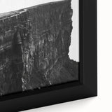 Close-up of a framed canvas wall art piece featuring a scenic landscape of cliffs and vibrant skies, showcasing rich colors and intricate details, ideal for home decor.