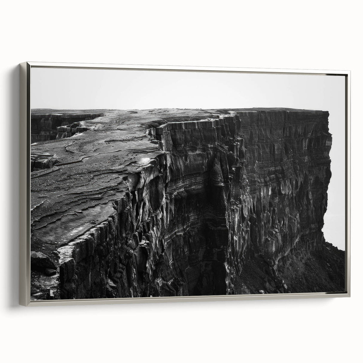 Framed canvas wall art showcasing a stunning landscape with dramatic cliffs in silver tones, enhancing modern decor with its elegant design and vivid colors.